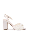Wedding Heels – Amabel Block Heel Wedding Shoes in ivory satin featuring a high block heel, ankle strap with buckle fastening, and pleated knot detail across the open toe, shown in side profile.
