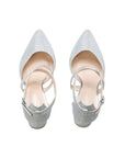Pair of silver glitter shoes with pointed toes and adjustable ankle straps, top view