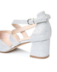 Close-up of the adjustable buckle, silver glitter upper and block heel