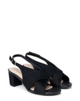 A pair of black slingback block-heel sandals with crisscrossing front straps, shown against a plain white background.