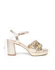 A single metallic gold platform sandal with an ankle strap and a knotted bow detail on the toe, shown in profile against a white background with a 31 cm heel height indicator.