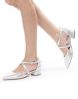 Model wearing Fabienne silver shimmer court shoes with crossover ankle straps