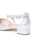 Close-up of the adjustable buckle, crossover straps and low block heel
