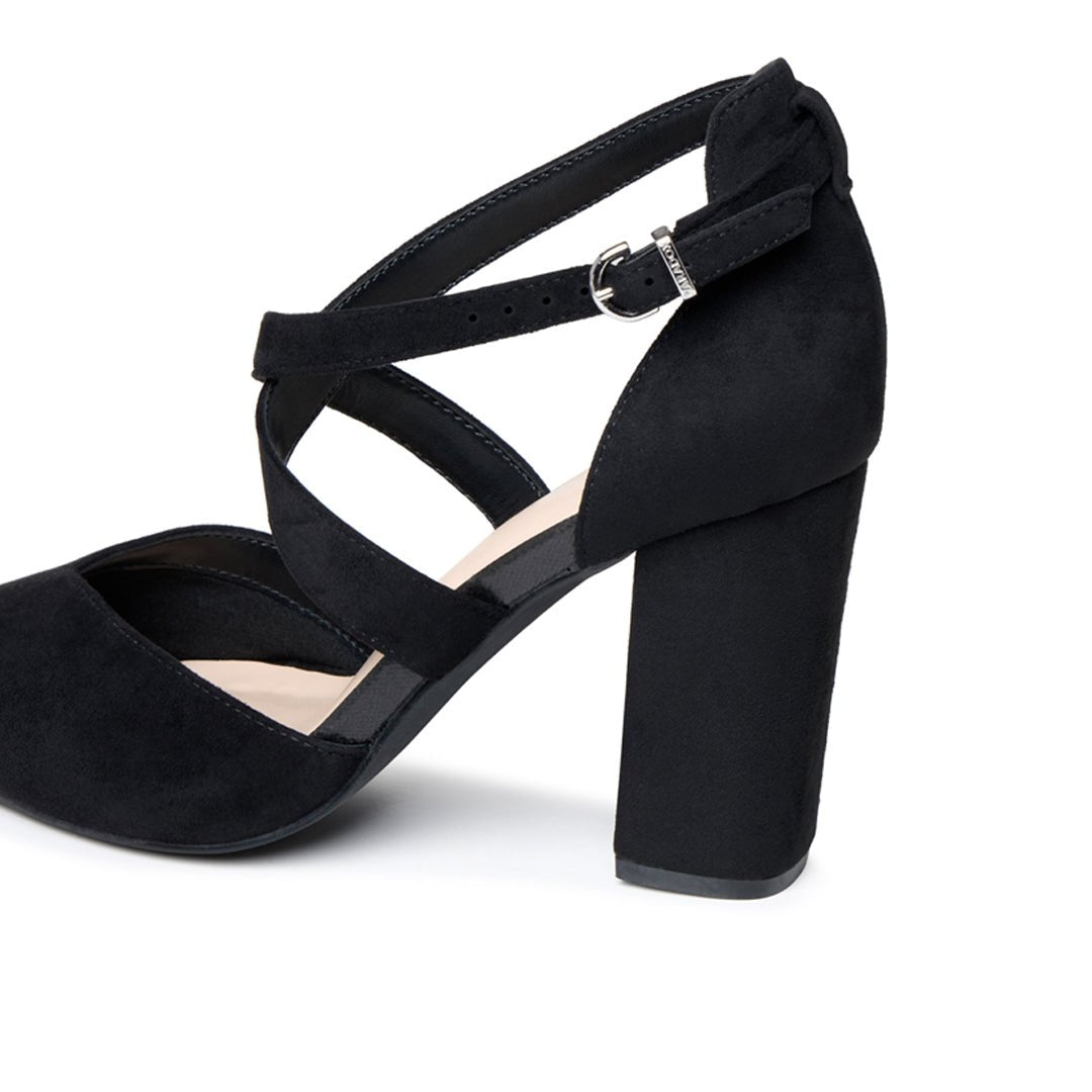 Close-up of the adjustable buckle, cross straps and black microsuede block heel