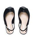 A pair of black slingback flat shoes with a wide bow-like strap across the top and a low block heel, shown from a top-down view on a white background. The brand name 'PARADOX' is visible on the insole.