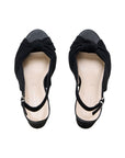 Pair of black microsuede sandals with knotted fronts and slingback straps, top view