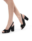 Model wearing Noreen black wide fit block heel sandals with knotted fronts