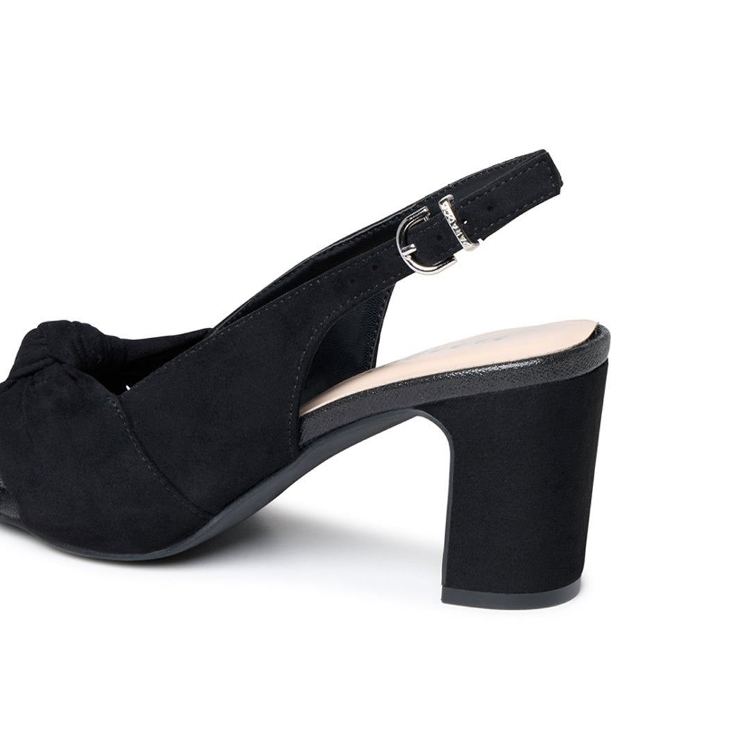 Close-up of the adjustable slingback buckle and black microsuede block heel