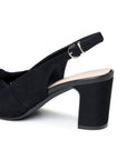 Close-up of the adjustable slingback buckle and black microsuede block heel
